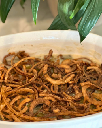 gluten free green bean casserole in a white baking dish