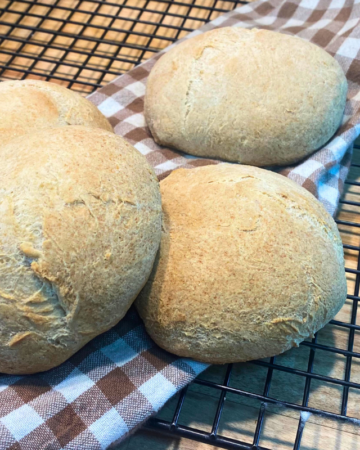 hamburger buns on a checkered tea towel
