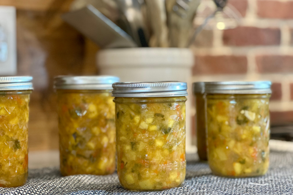 several jars of water bath canning peach salsa