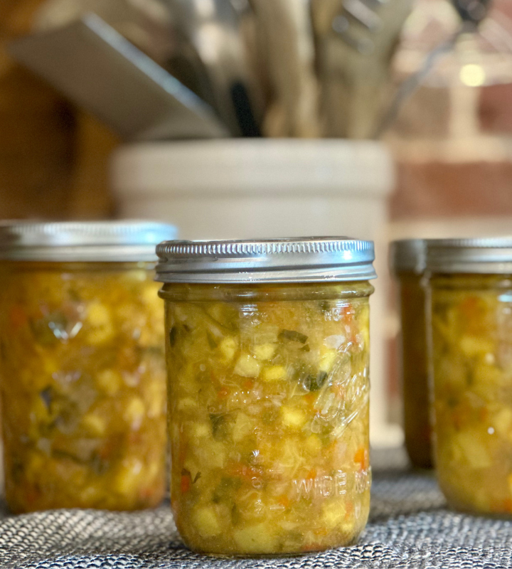 several jars of peach salsa on a towel